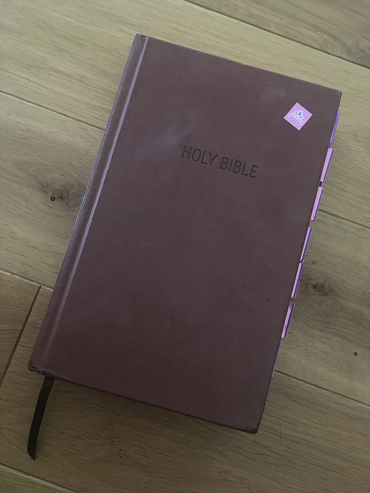 Cheap Wal-Mart bible with a pink sticker on it 